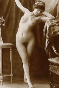 a mature dark-hued chick playing with her bare fur covered hard-on